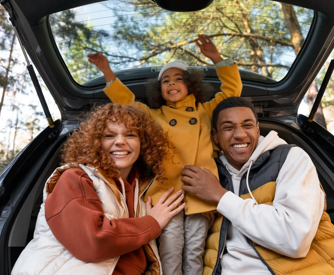 Family loaded into the back of a vehicle